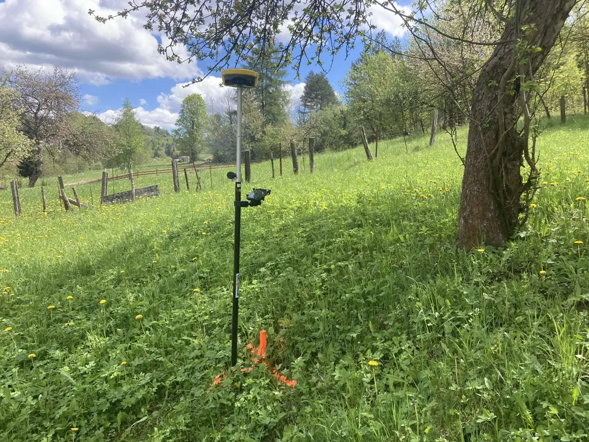 GNSS prijímač na výtyčke pri meraní v teréne. Fotografia z našej práce.